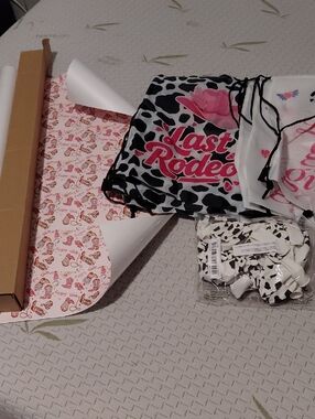 Last Rodeo Cow Print Drawstring Tote with Pink Logo